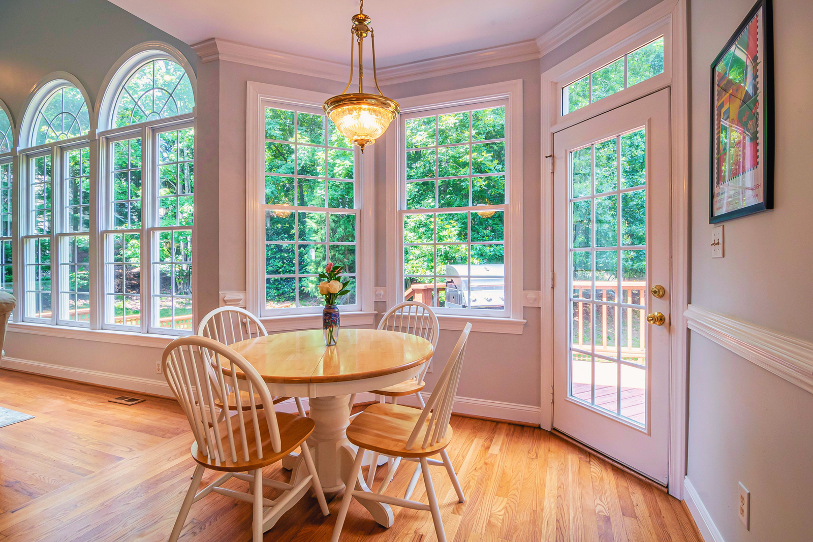 Pinecrest home breakfast nook with impact-rated windows overlooking the backyard